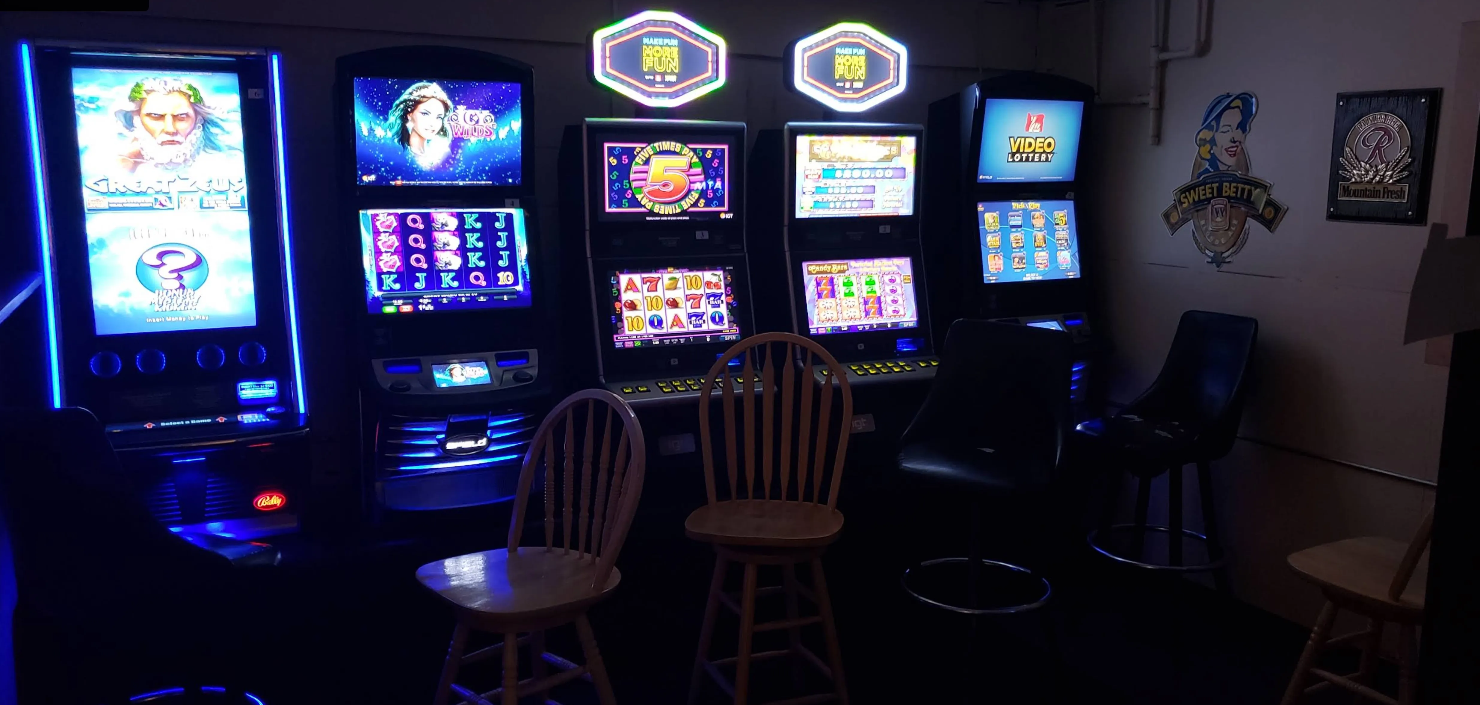 The video lottery room aglow — a quiet row of machines and stools in the corner of the pub.